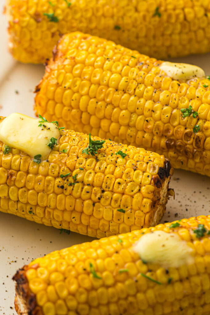Cooked corn with slabs of butter.
