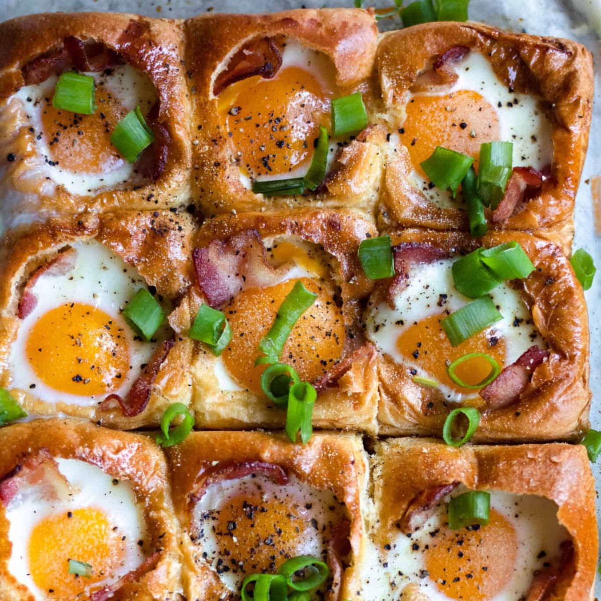 Egg in a Hole Bake sprinkled with green onions.