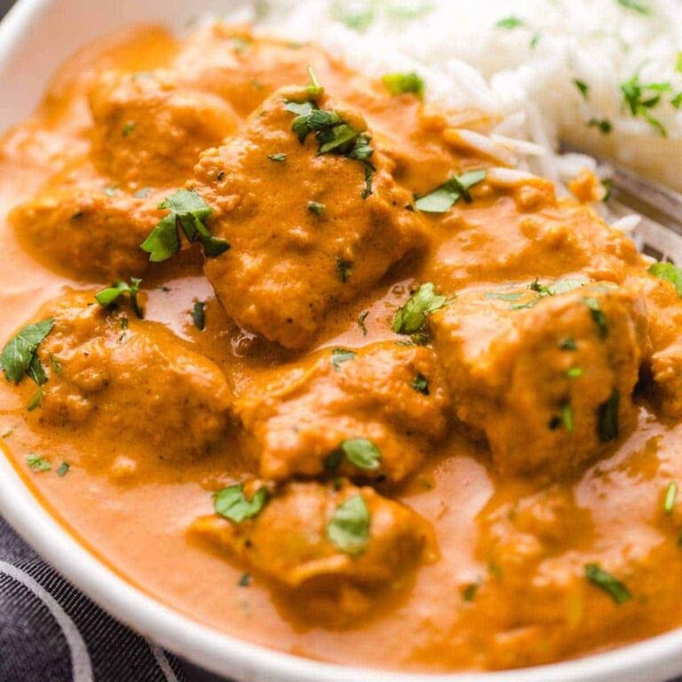 Butter chicken in a bowl with rice.
